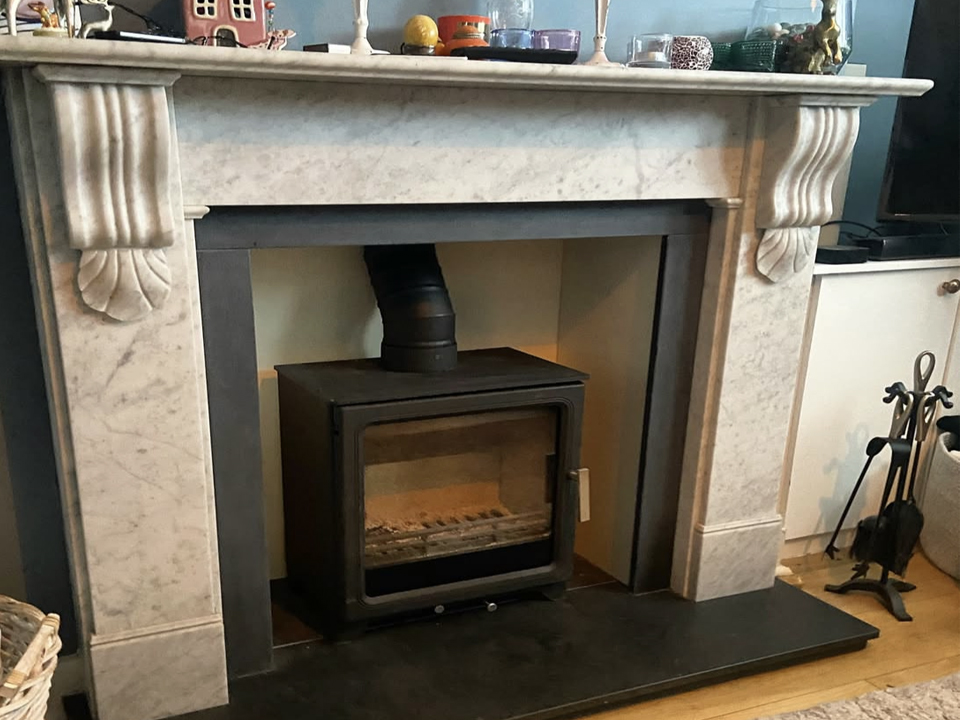 Marble fireplace surround with contrasting slate slips and hearths