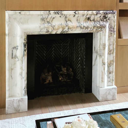 Custom Bolection Style Fireplace from Calacatta Monet Marble Slab