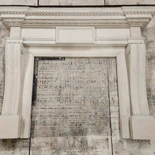 Classical ornamentation in Limestone Fireplace Mantel