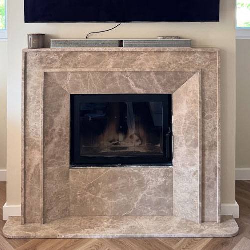 Modern marble fireplace mantel in Emperador Light