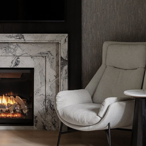 marble fireplace mantel and chair.jpg
